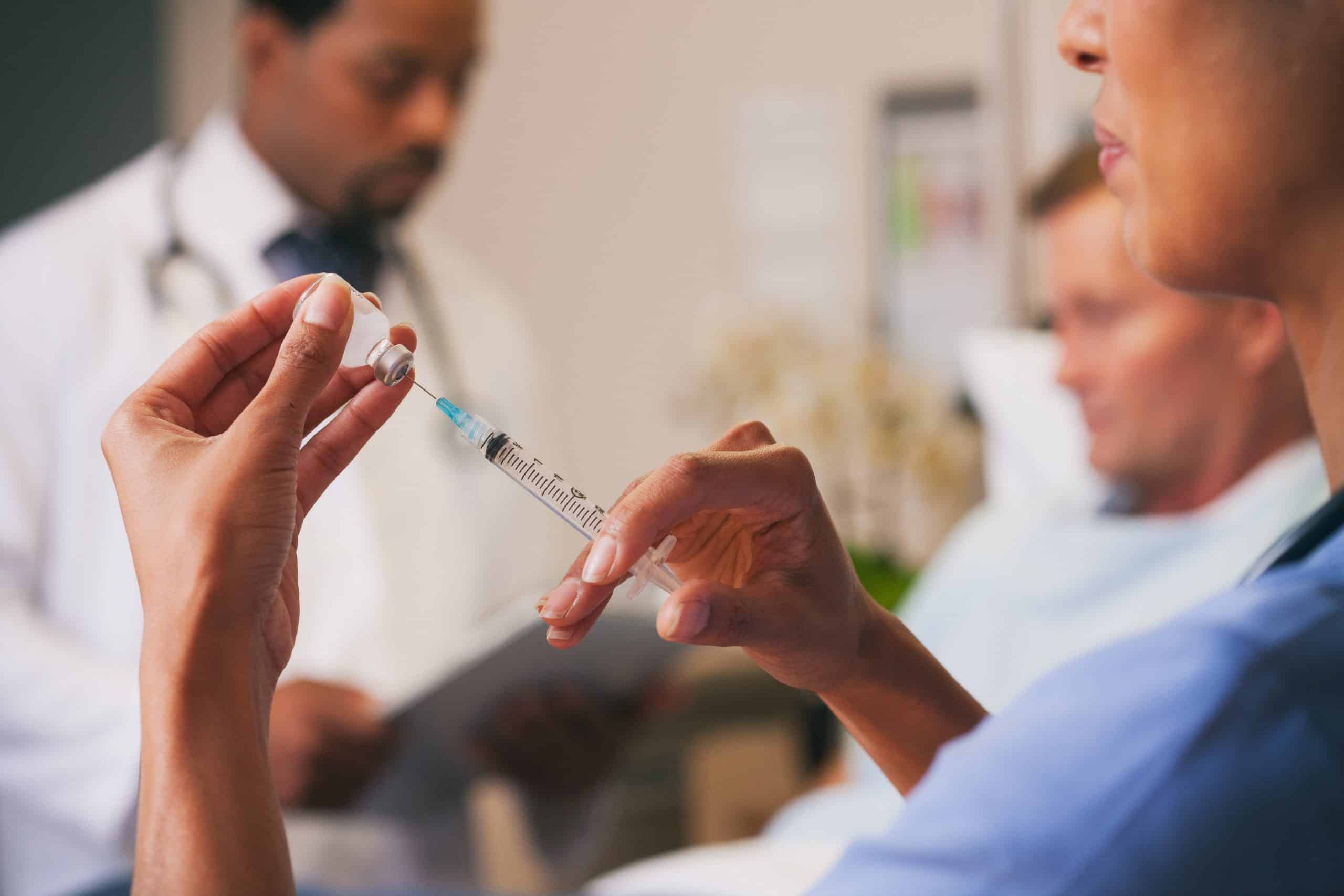 Hospital: Female Assistant Preparing Syringe For Injection – DMC Healthcare